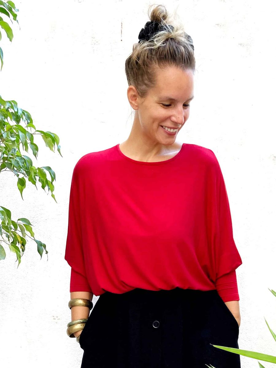 Mirta the owner of the store wearing the batman long sleeve (7/8) top in red with style.