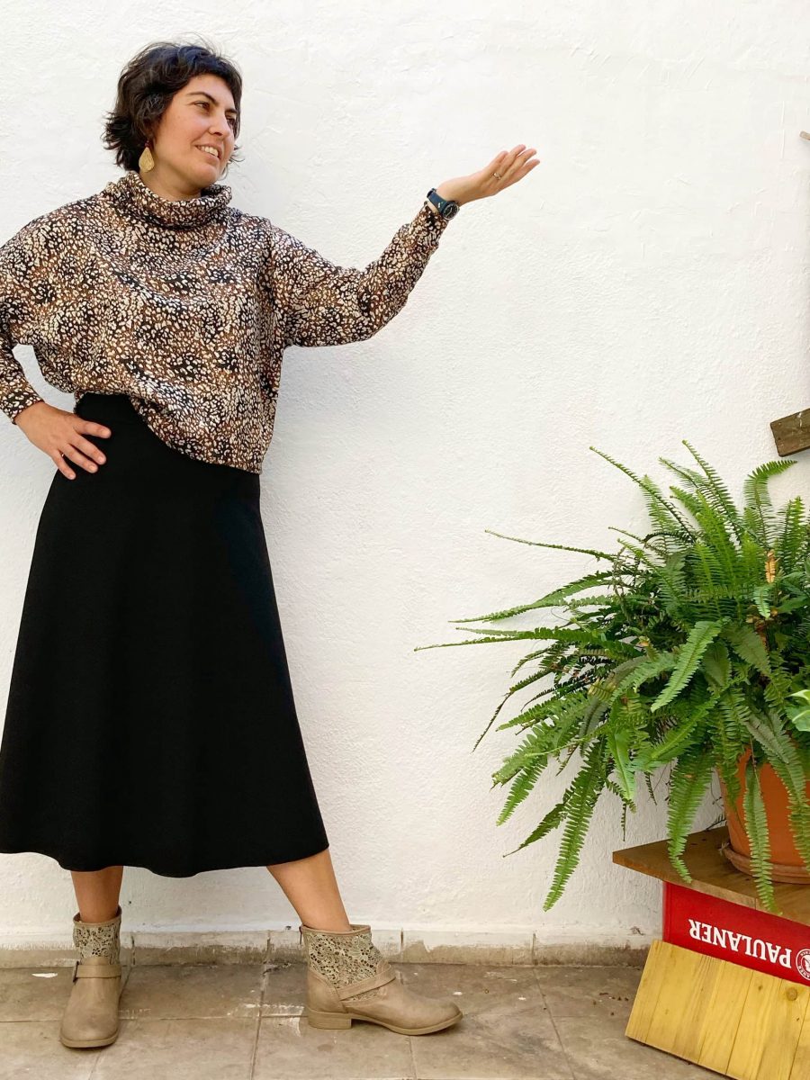 nuestra clienta sonriendo con su falda de lama punto roma negra en el patio interior de japamala en gracia barcelona